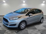 une Ford Fiesta argentée garée sur un sol en carrelage à damier