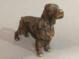bronze statue of a dog on a white surface