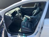 the interior of a car with the door open and the driver ' s seat down