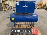 a blue compressor sitting on top of a pallet in a warehouse