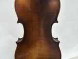 an old violin sitting on top of a table next to a book