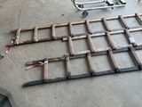 some pieces of wood are laying out on the floor next to a cart