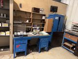 an image of a work area with a desk and cabinets