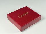a red box with gold lettering on it on a white surface
