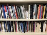 a book shelf with many books on it in a room