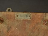 a piece of wood that has a metal tag on it