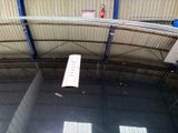 a white sign hanging from the ceiling of a building