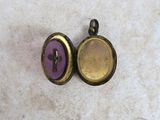 two purple and gold lockes sitting on top of a white surface