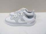 white and grey nike air force sneakers on a white surface