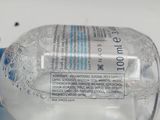 a bottle of water sitting on a table next to a toothbrush