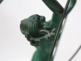 a statue of a woman holding a flower in her hand