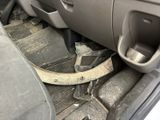 a broken steering wheel in the back seat of a car