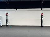 two boxing bags hanging from the ceiling in a gym