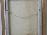 an old picture frame sitting on top of a wooden table