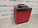 a red and black box sitting on top of a metal table