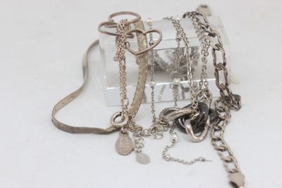 a small clear box with a bunch of jewelry inside of it