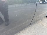 a reflection of a man in the side of a car