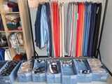 a closet filled with lots of different colored shirts