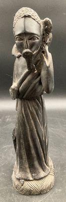 a statue of a woman holding a bird in her hands