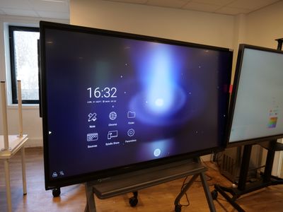 a large flat screen tv sitting on a stand in a room