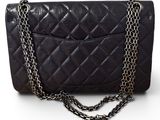a close up of a black purse with a chain around it
