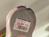 a close up of a pink shoe with a price label on it
