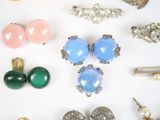 many different types of jewelry on a white surface