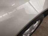 a close up of a car ' s front bumper and tire
