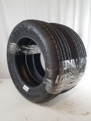 a close up of a tire wrapped in plastic on a white surface