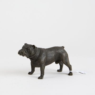 a small statue of a dog standing next to a computer mouse