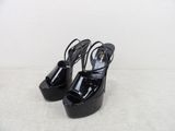 un gros plan sur une paire de chaussures noires posées sur une surface blanche