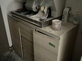 a kitchen with a stove, sink, and refrigerator in it