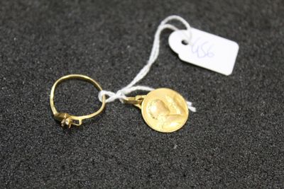 a close up of a gold ring with a coin on it