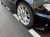 black bmw car parked in a parking space in front of a building