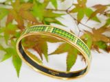 an image of a bangle with a green and yellow design on it