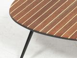 an oval coffee table with a wooden top and black legs