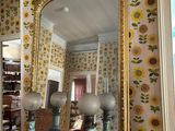 a mirror and vases on a table in a room