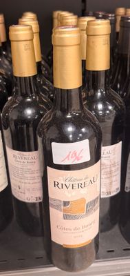 many bottles of wine sitting on a shelf in a store