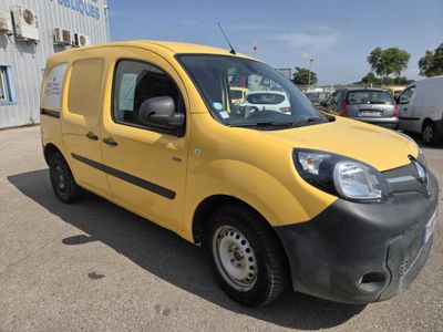 the yellow van is parked in the parking lot outside of the building