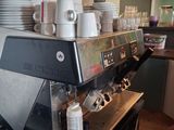 a coffee machine that is on the counter in the kitchen