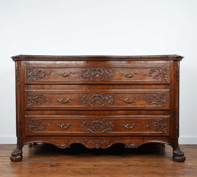 an antique chest of drawers on a wooden floor