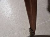 a wooden table with a wooden top and legs on it