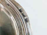 a close up of a silver plate on a table