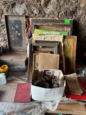 a pile of books on a table next to a chair