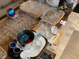 a table full of dishes and glasses on the counter