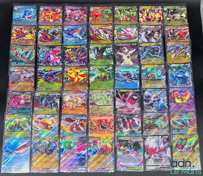 a large collection of pokemon cards are displayed on a table