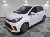 une voiture blanche garée sur un sol en damier dans un garage