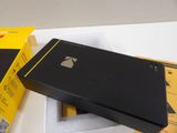 a black box with a yellow sticker on it next to a black box with a yellow sticker on it