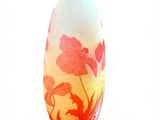 a glass vase with a red and yellow design on it
