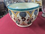 a bowl that is sitting on a table with a clock in the background